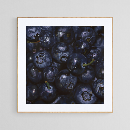 The original painting “Blueberries" by Hannah Kilby from Hannah Michelle Studios, displayed as a 12x12" fine art print in a 16x16" oak frame.