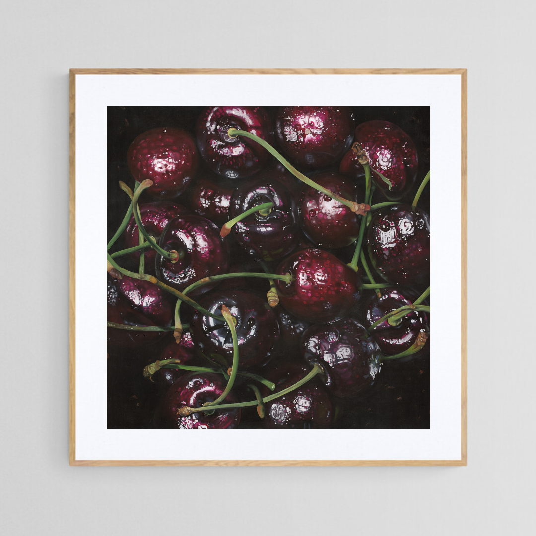 The original painting “Cherries" by Hannah Kilby from Hannah Michelle Studios, displayed as a 12x12" fine art print in a 16x16" oak frame.