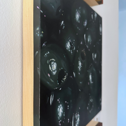 A close-up, edge view of the original painting "Black Olives" by Hannah Kilby from Hannah Michelle Studios.