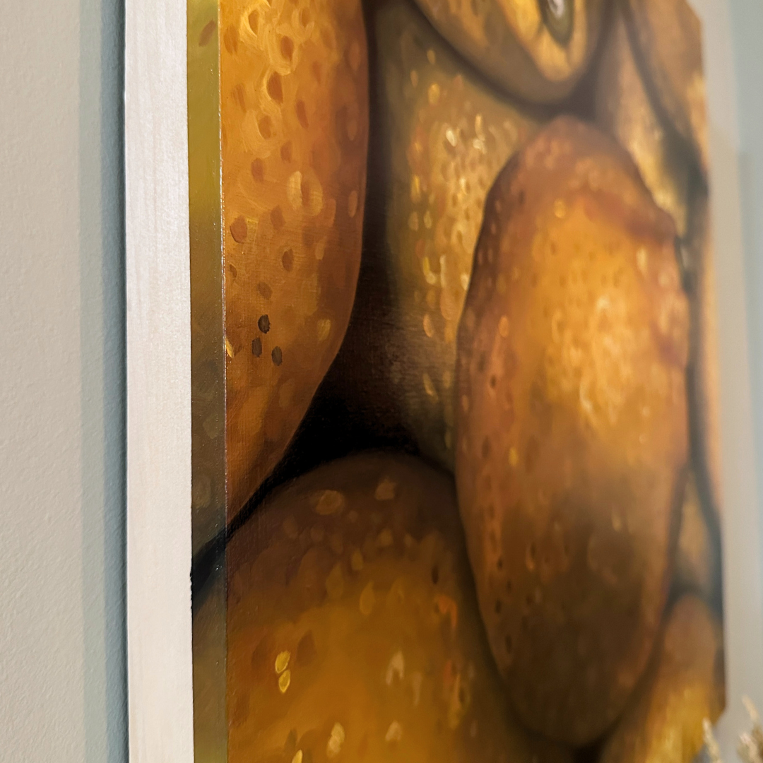 A close-up, edge view of the original painting "Lemons" by Hannah Kilby from Hannah Michelle Studios.